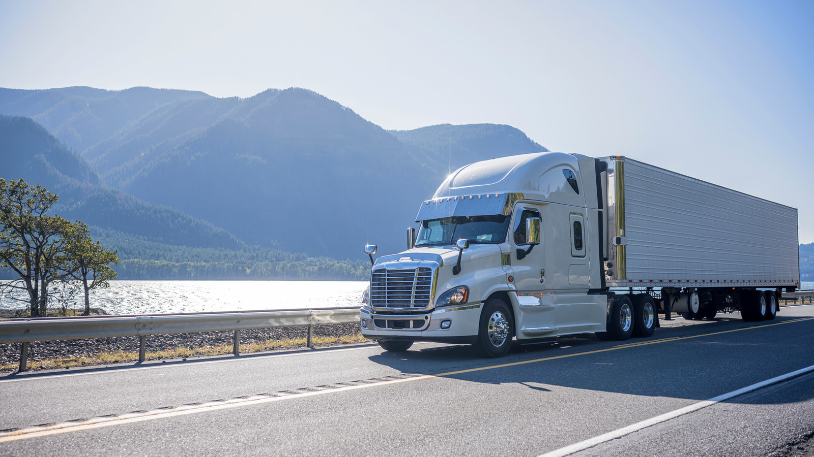 Truck driving by a lake